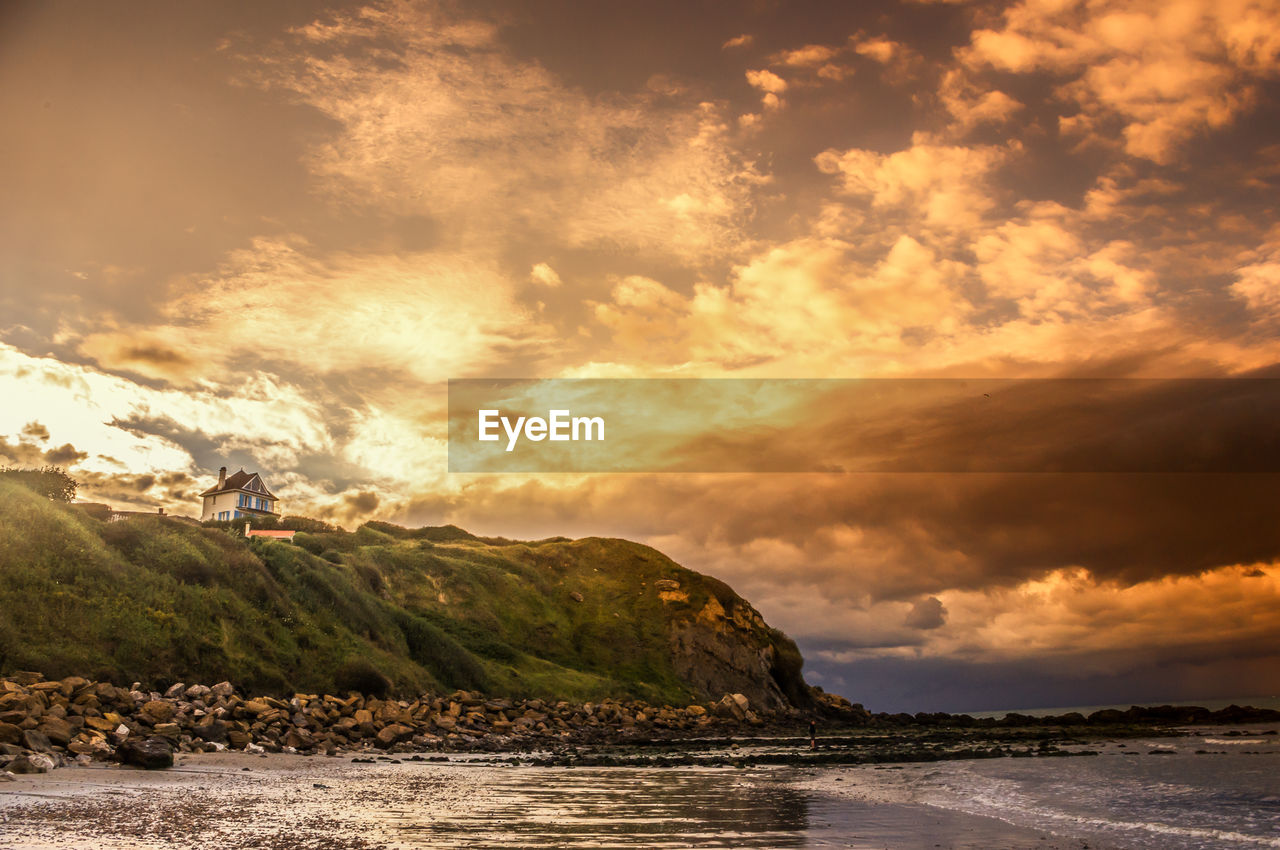 Scenic view of mountains against cloudy sky