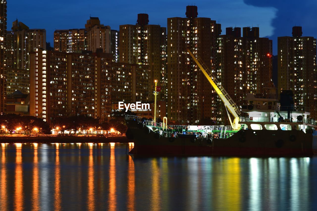 ILLUMINATED BUILDINGS AGAINST SKY AT NIGHT