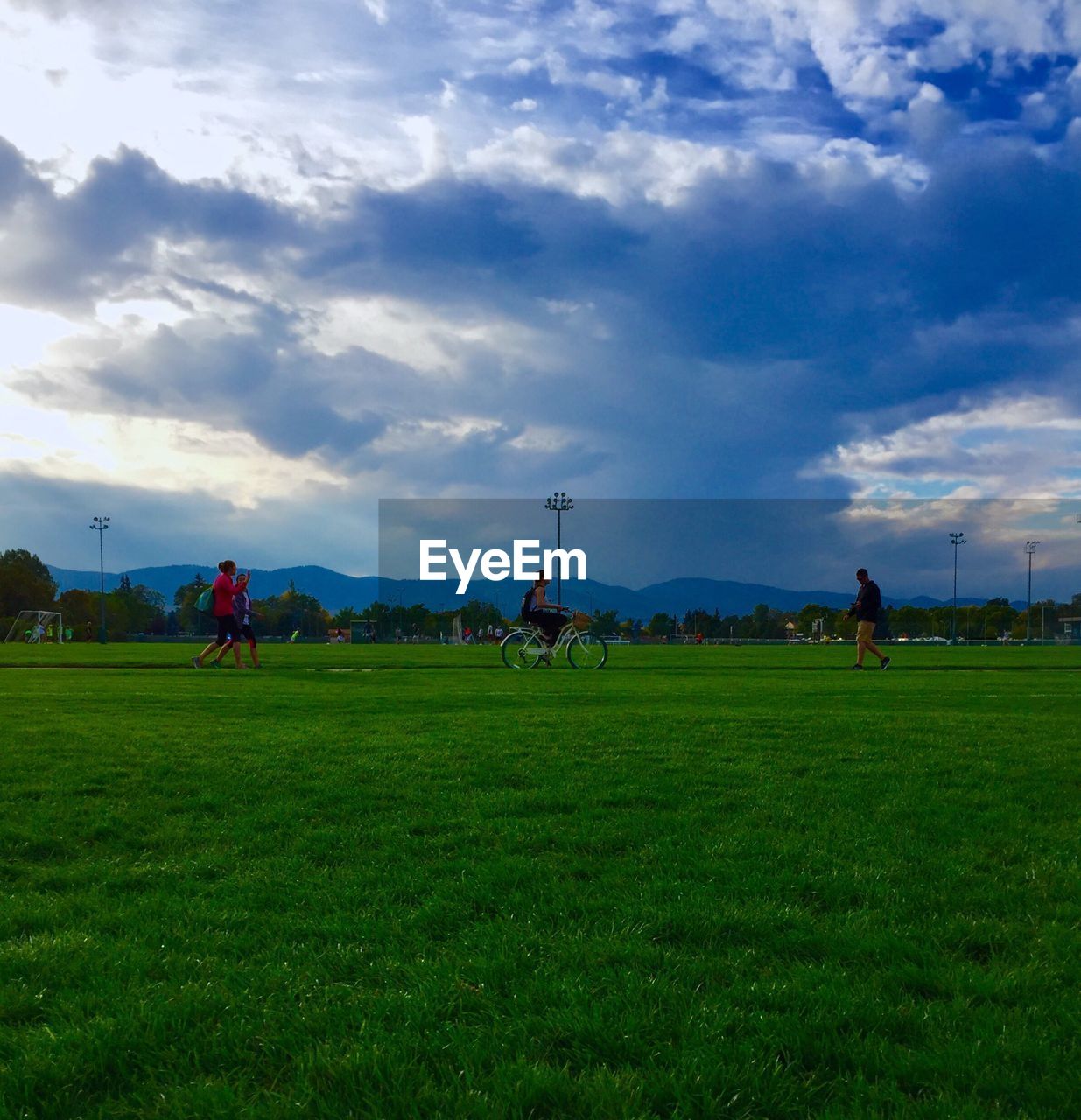 VIEW OF GRASSY FIELD AGAINST CLOUDY SKY