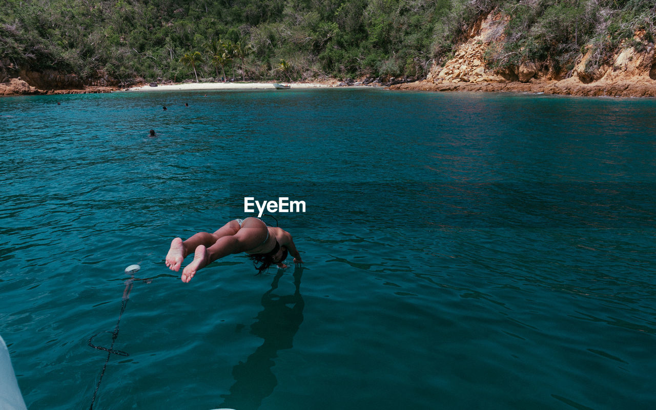 High angle view of young woman diving in sea