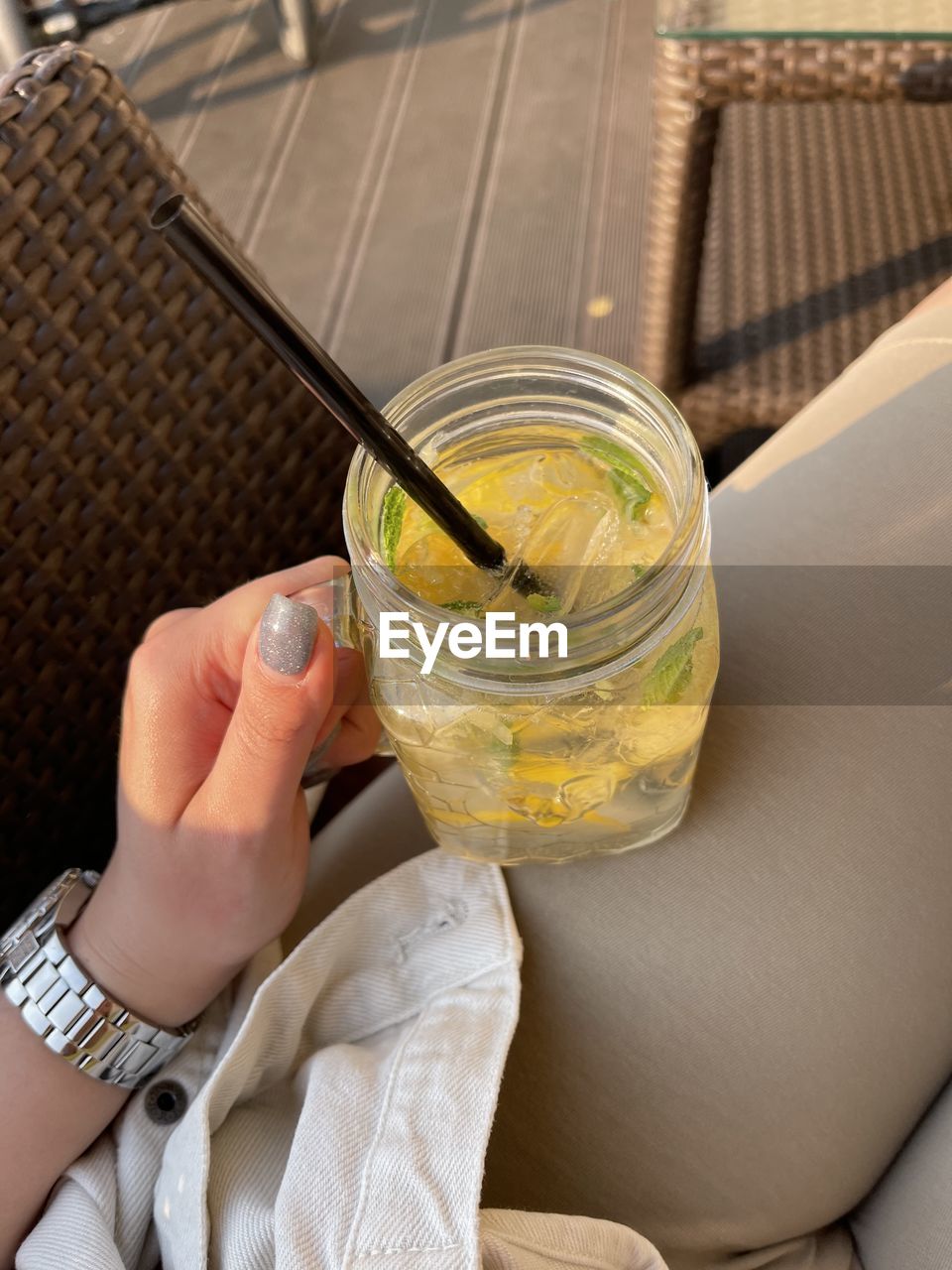 MIDSECTION OF PERSON HOLDING ICE CREAM IN GLASS