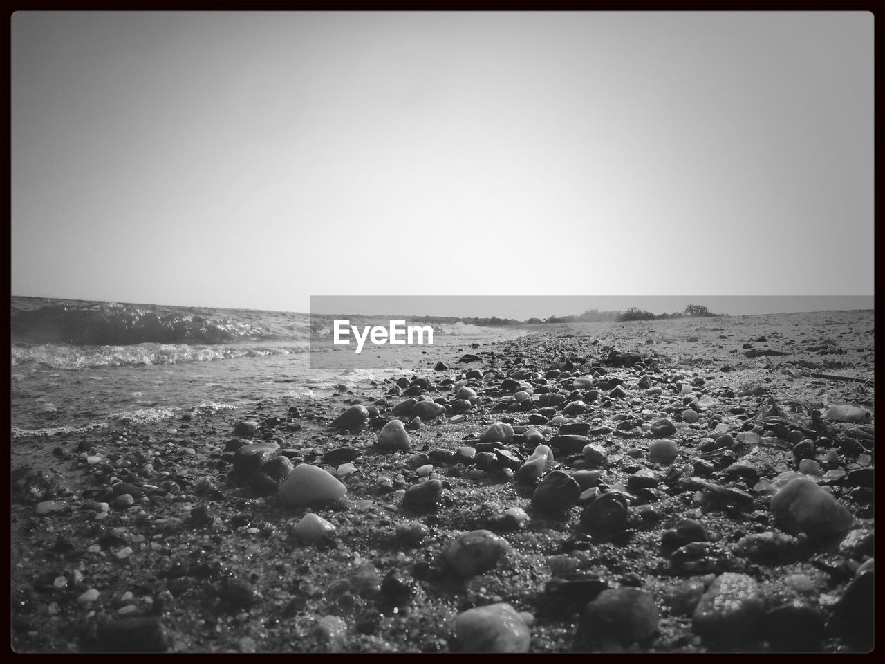 Surface level shot of pebbles on empty beach