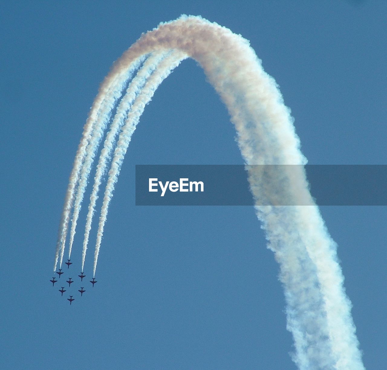 Low angle view of fighter planes performing airshow on clear sky