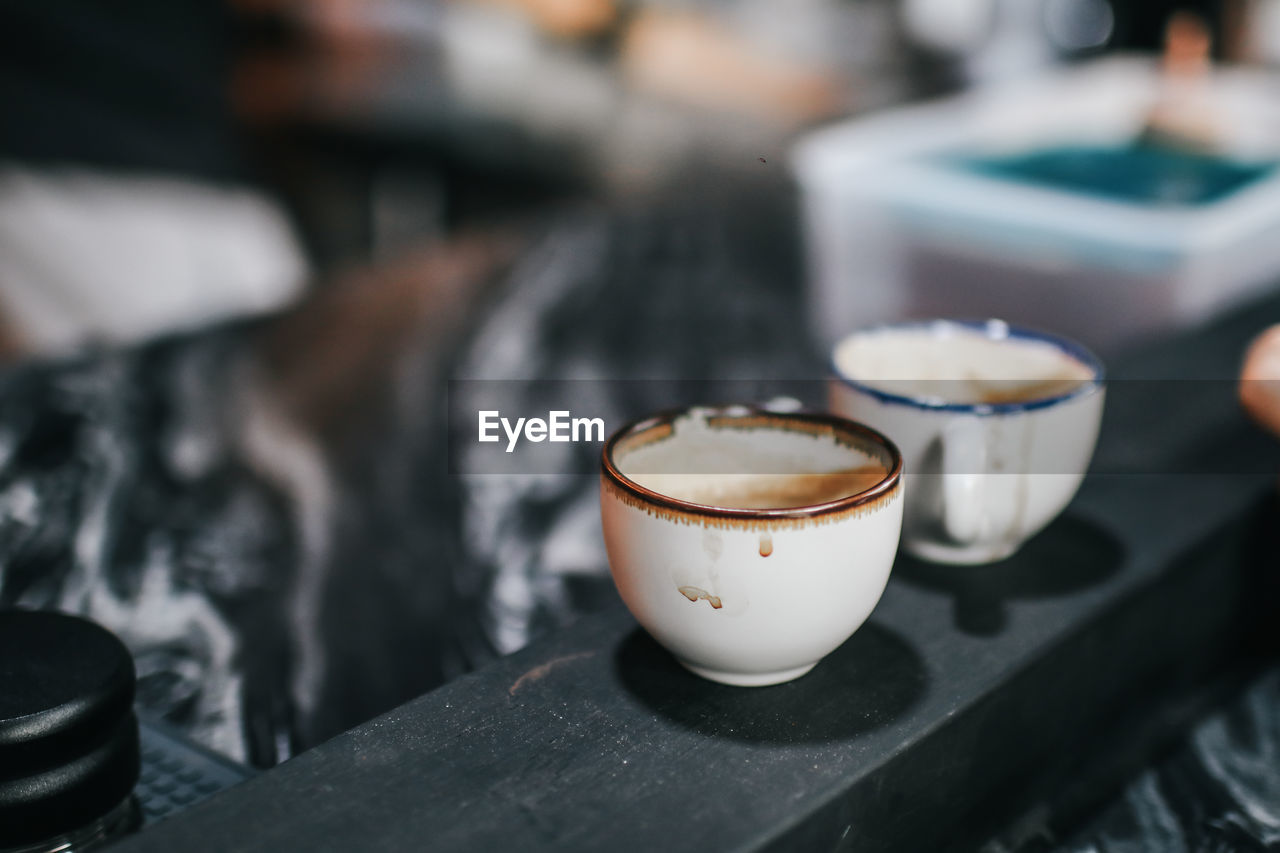 CLOSE-UP OF COFFEE ON TABLE AT CAFE