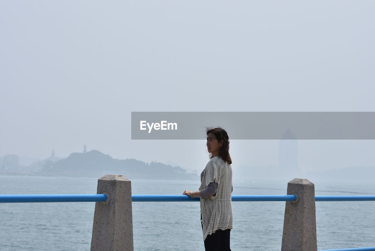 WOMAN LOOKING AT SEA