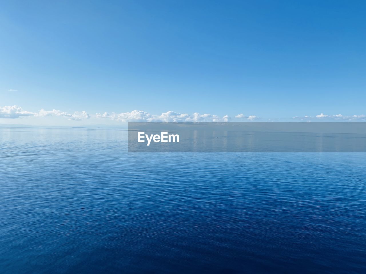 Scenic view of sea against blue sky