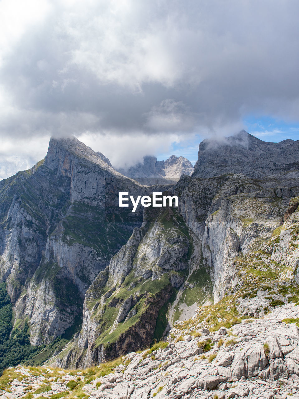 Mountainous landscape with gray clouds in summer day