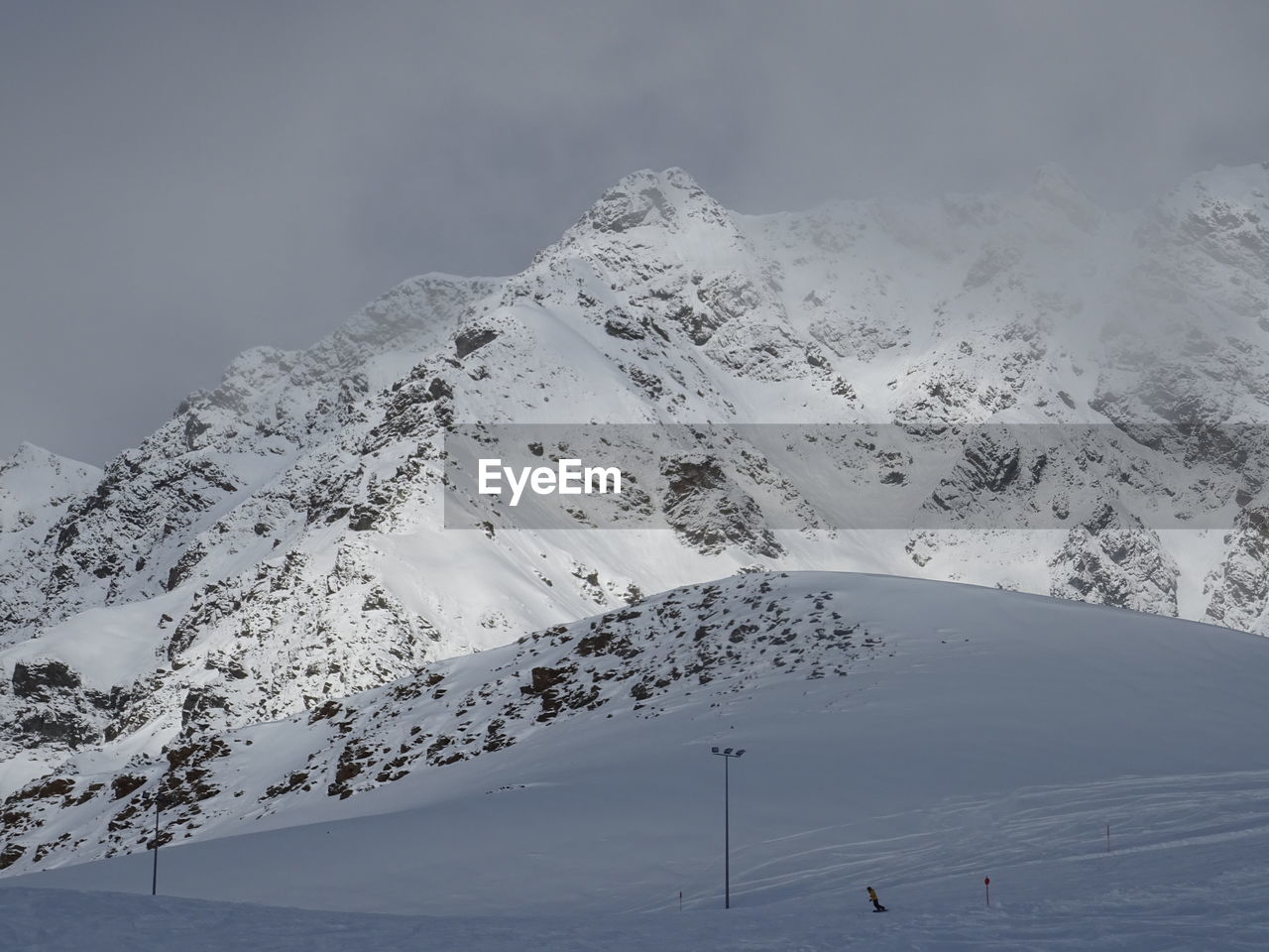 SNOW COVERED MOUNTAIN AGAINST SKY