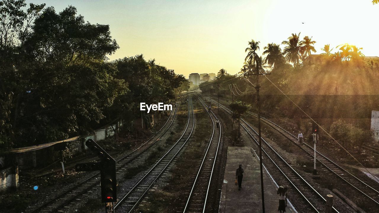 Railroad tracks against sky during sunset