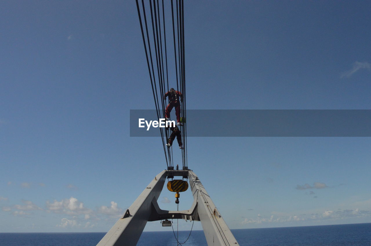 LOW ANGLE VIEW OF SAILBOAT AGAINST BLUE SKY