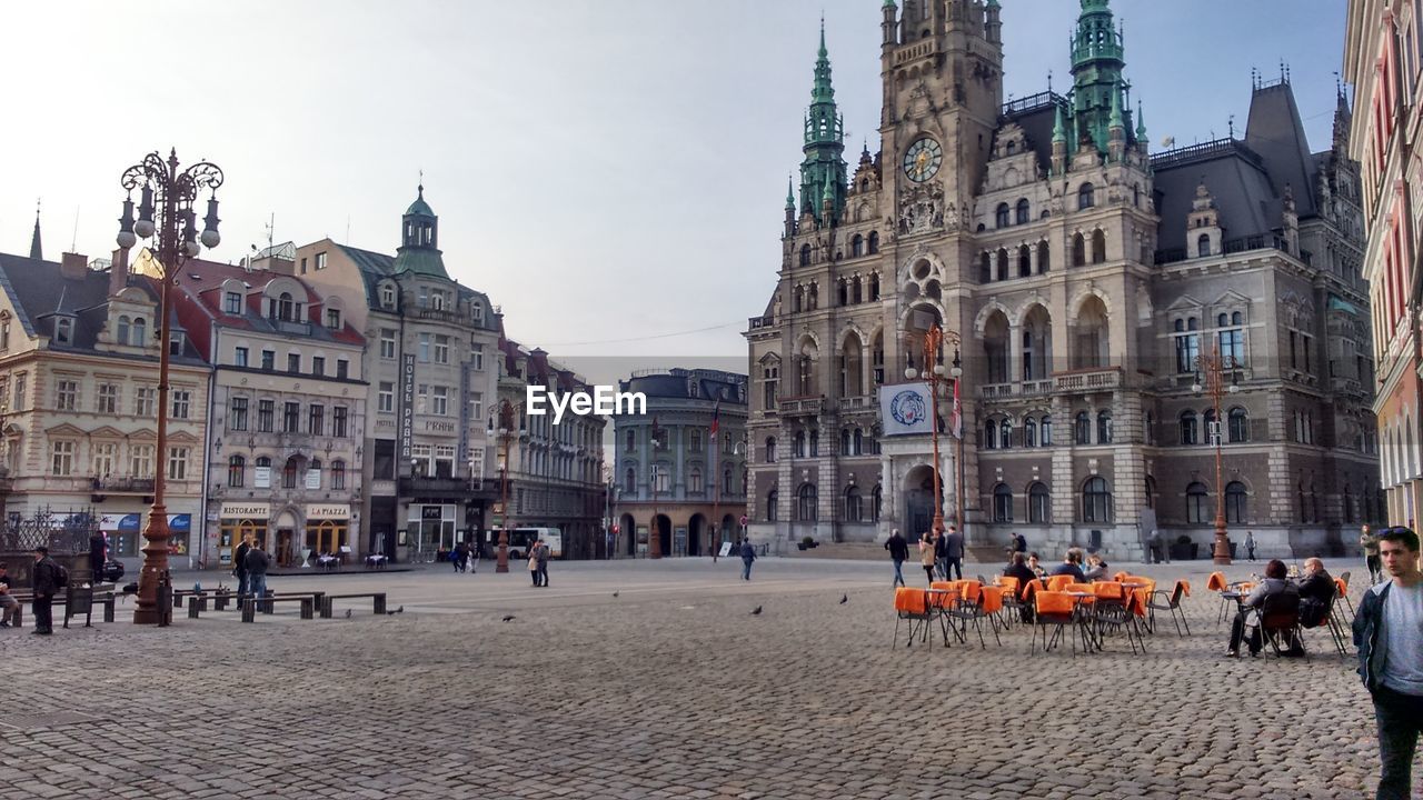 PEOPLE WALKING ON STREET IN FRONT OF CATHEDRAL