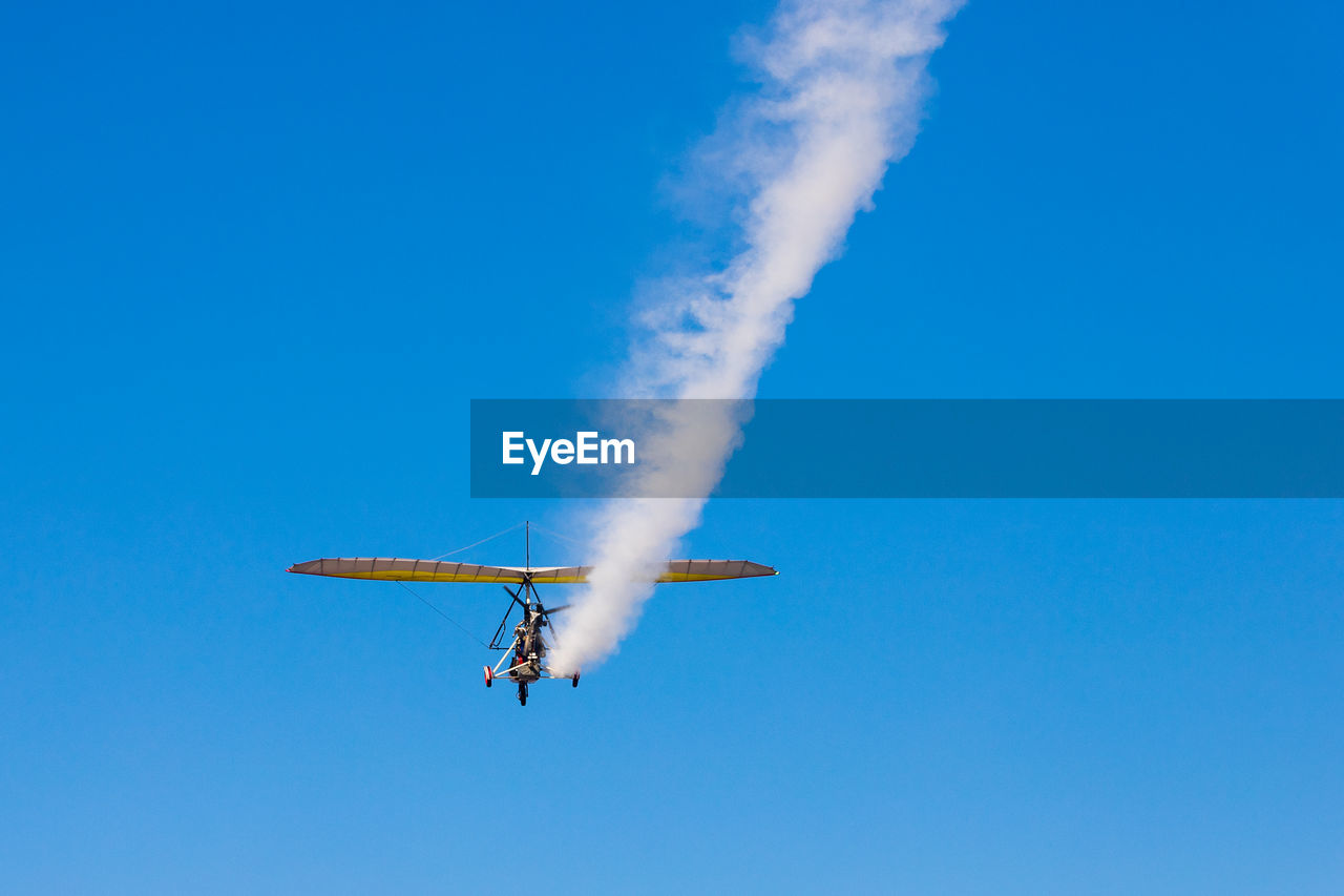 air vehicle, flying, airplane, sky, transportation, mode of transportation, blue, on the move, air show, vapor trail, motion, smoke, clear sky, nature, aerobatics, wing, mid-air, vehicle, cloud, low angle view, day, aviation, sunny, no people, aircraft, outdoors, air sports, general aviation, speed, skill, travel, performance, stunt