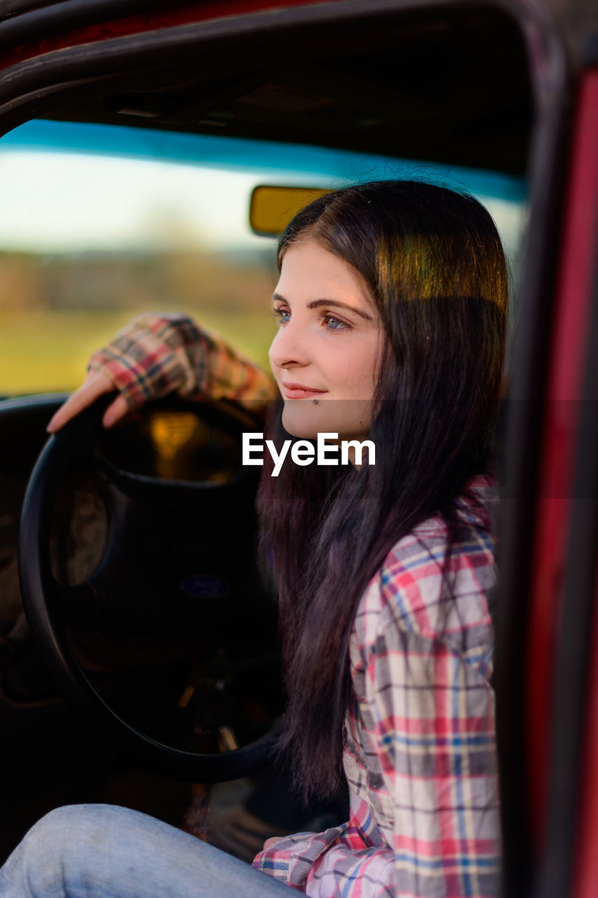 Portrait of woman in red truck