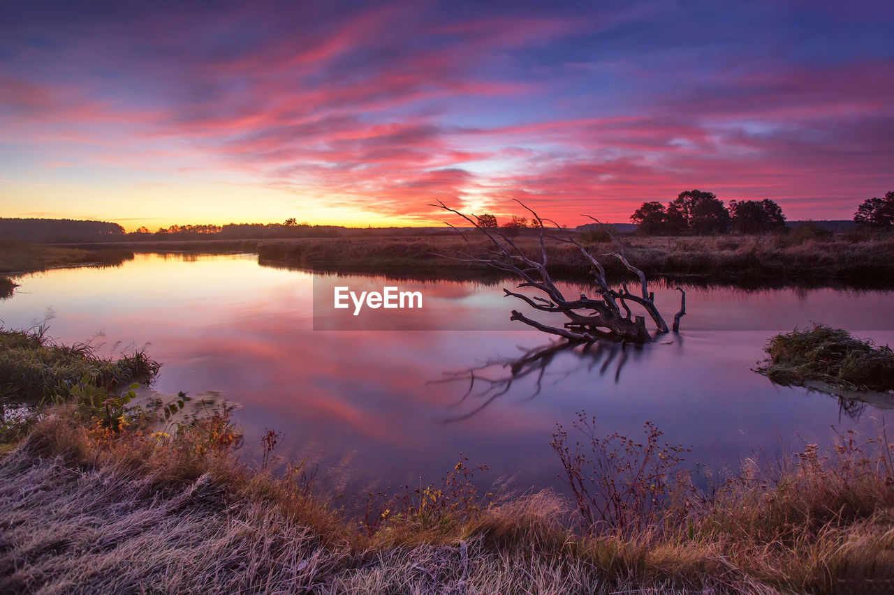 Scenic view of landscape against sky at sunset