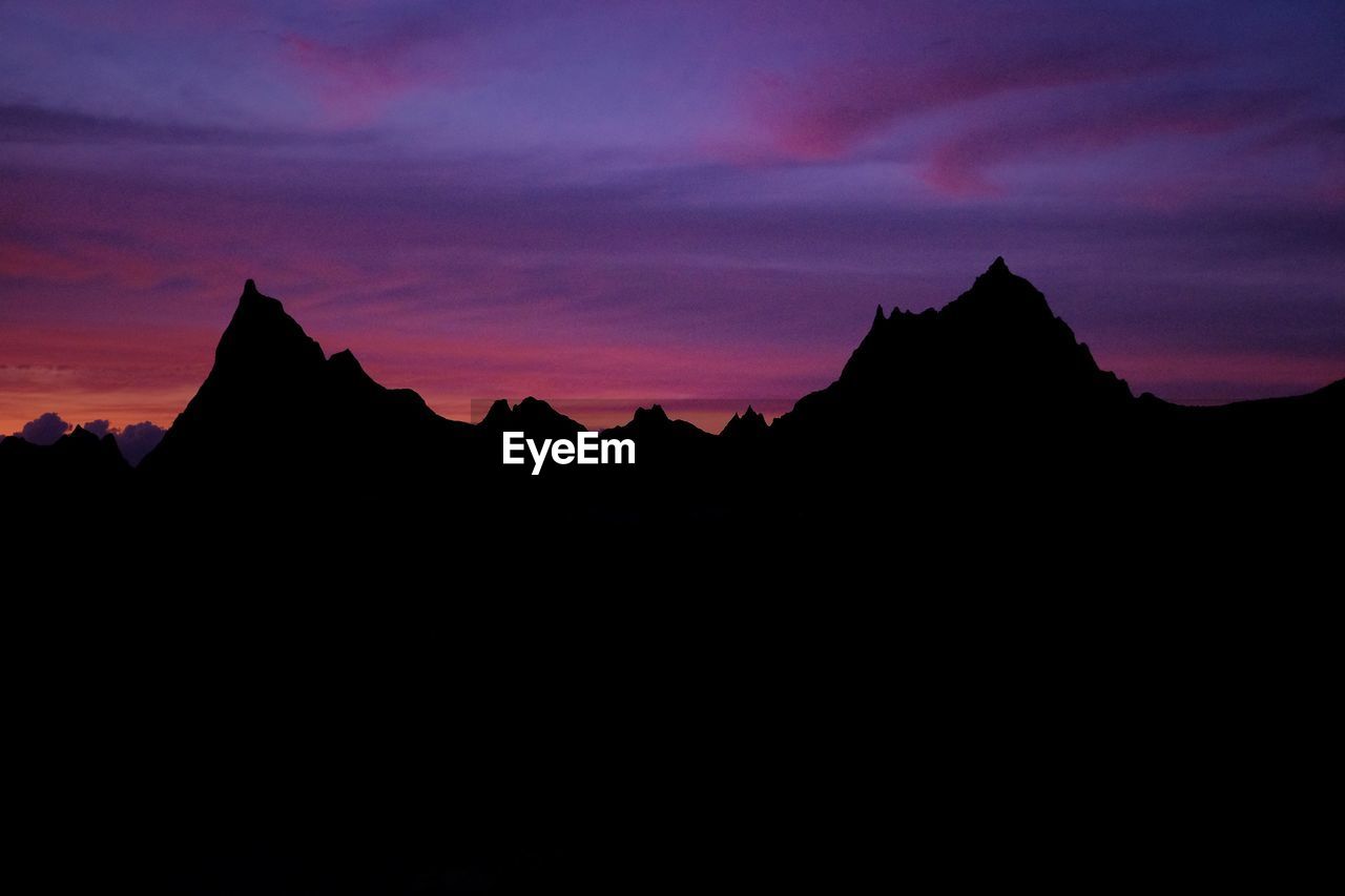 Silhouette mountains against sky at sunset