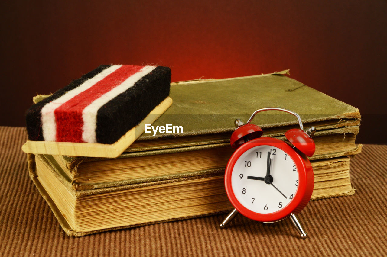 CLOSE-UP OF CLOCK ON BOOK