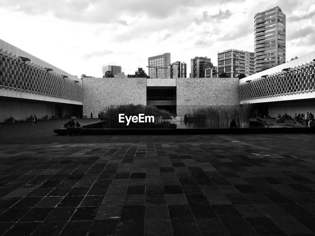 View of buildings in city against cloudy sky