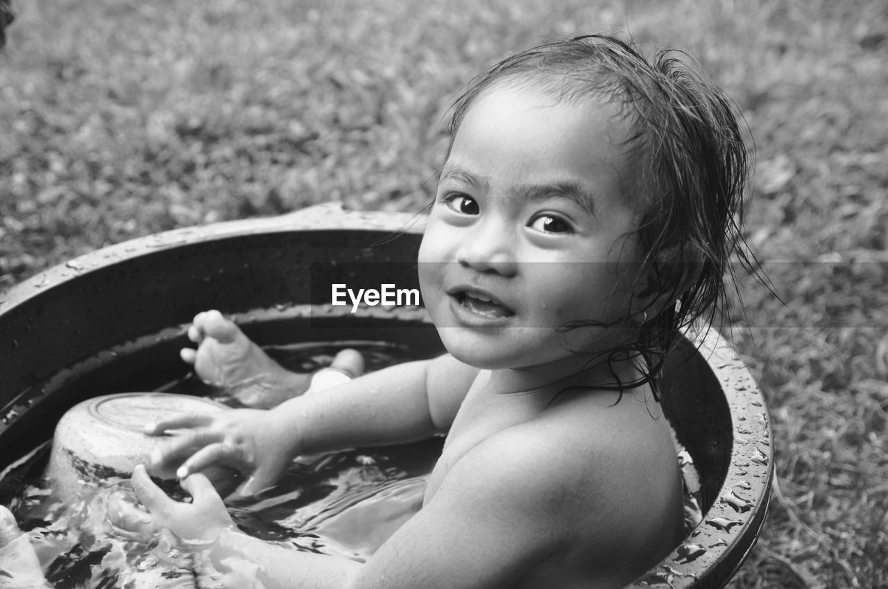 Portrait of cute girl sitting in bathtub