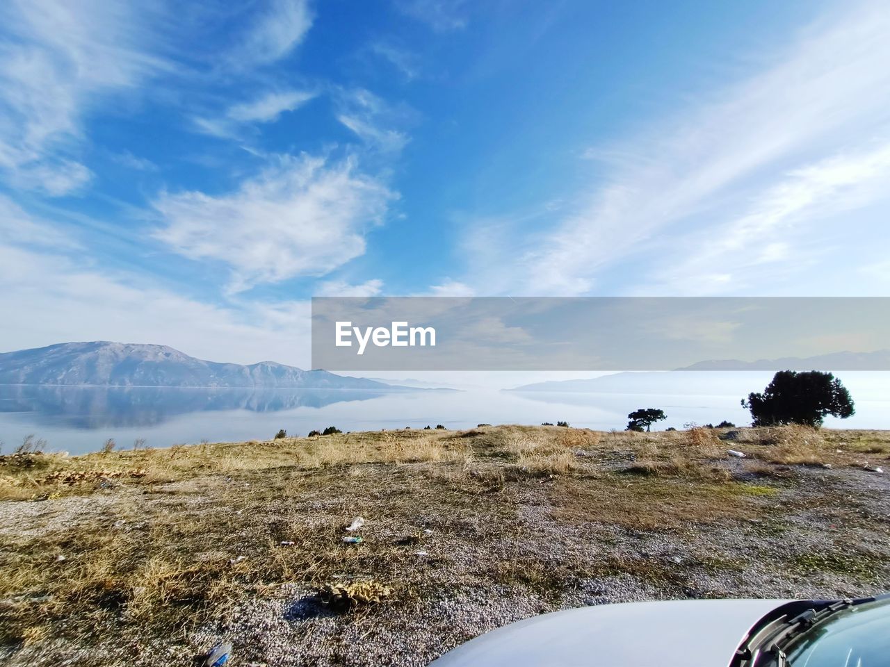 SCENIC VIEW OF LAND AND MOUNTAINS AGAINST SKY