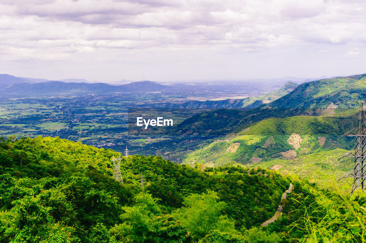 SCENIC VIEW OF GREEN LANDSCAPE AND MOUNTAINS AGAINST SKY