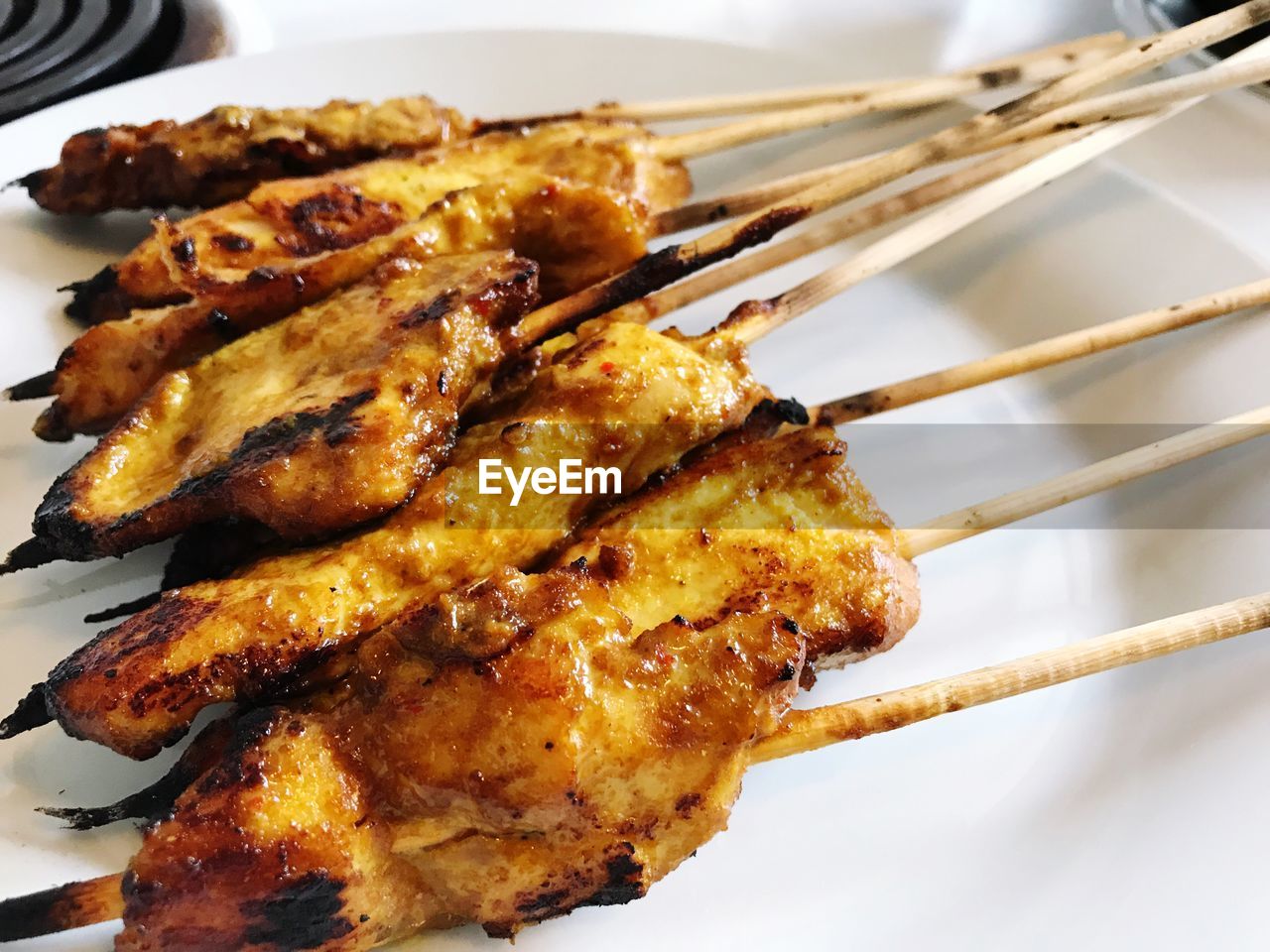 Close-up of meat on skewers in plate 