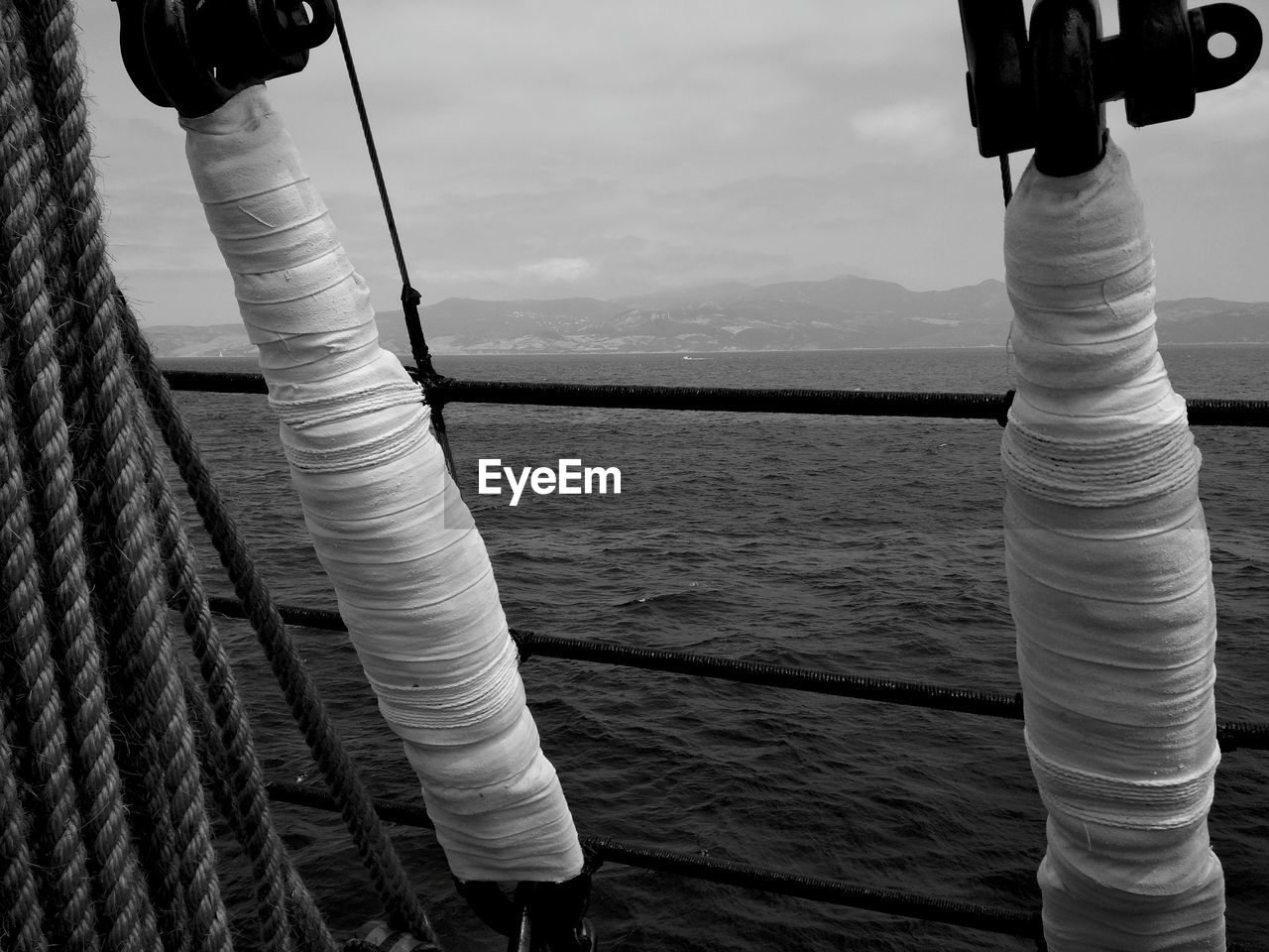 CLOTHES HANGING ON ROPE AGAINST SEA AND SKY