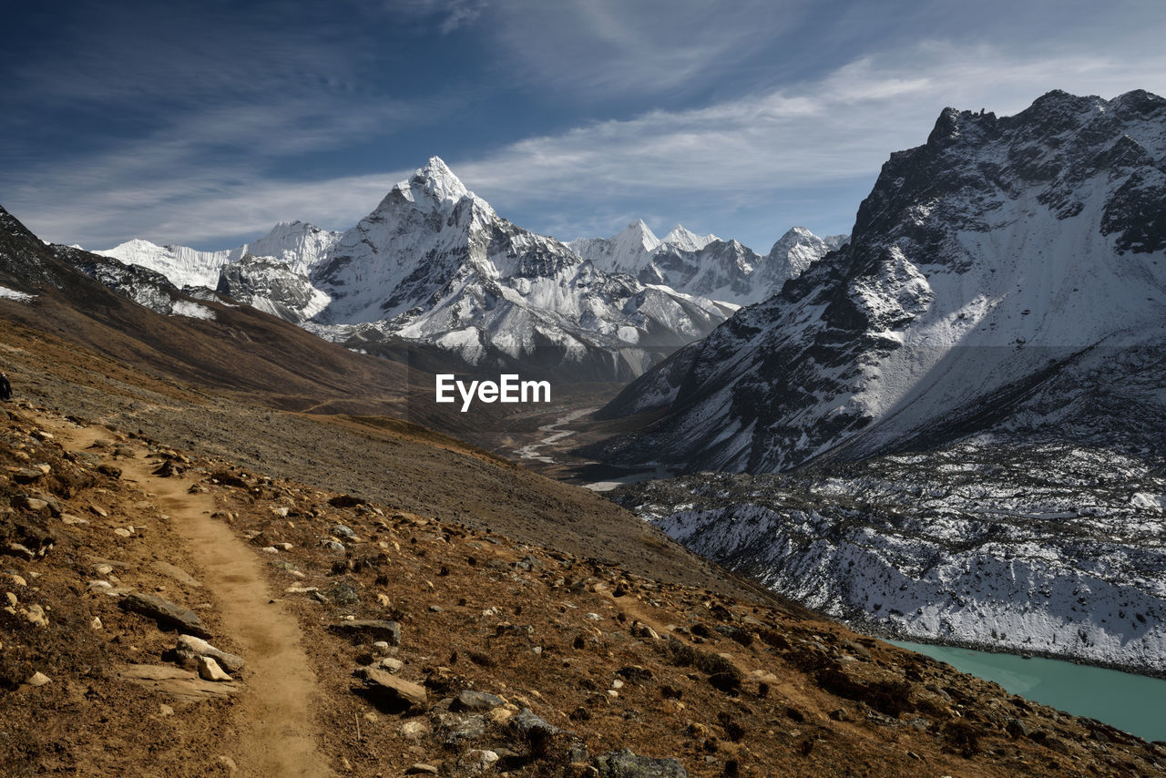 Scenic view of mountains against cloudy sky