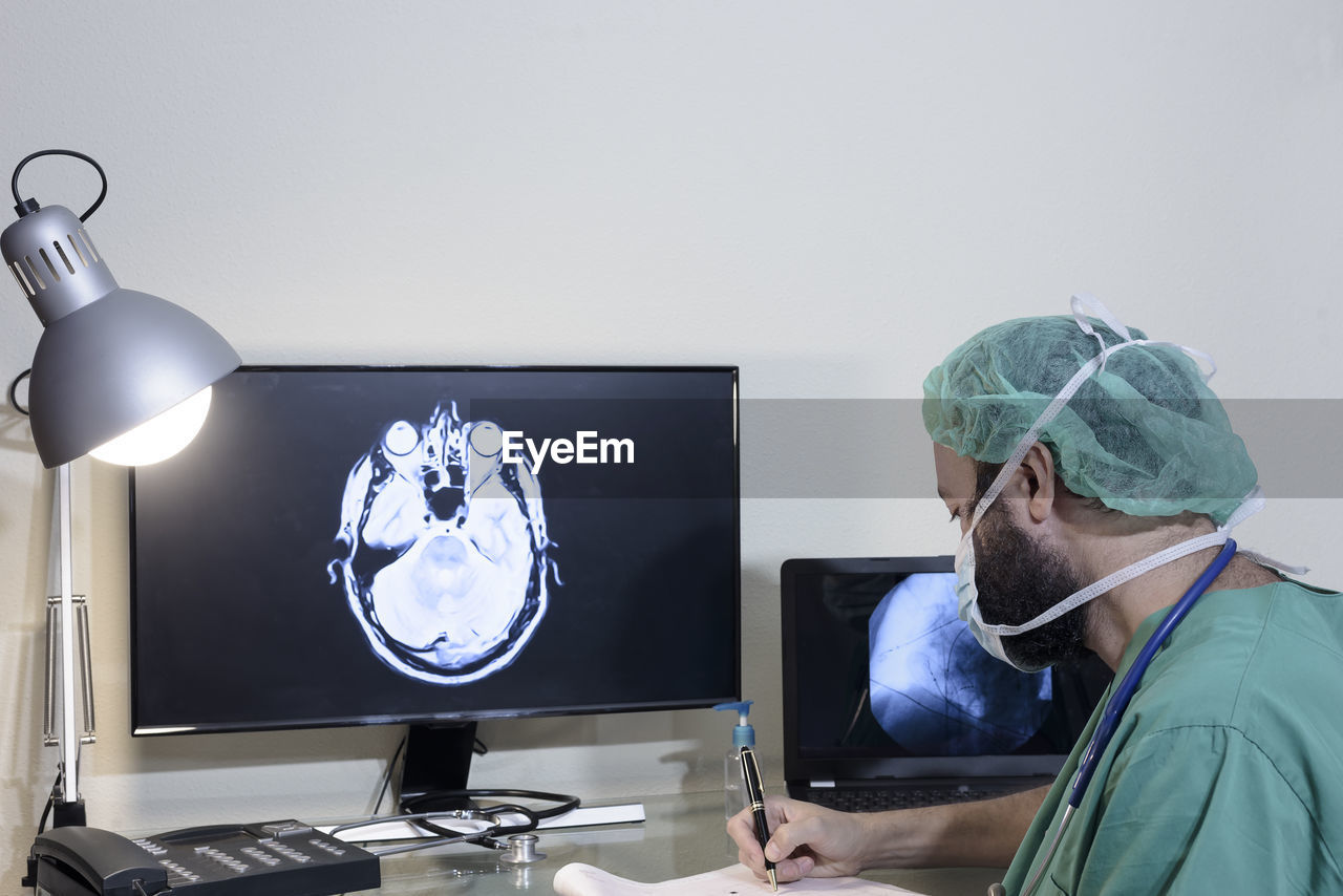 Doctor examining medical x-ray on computer at office