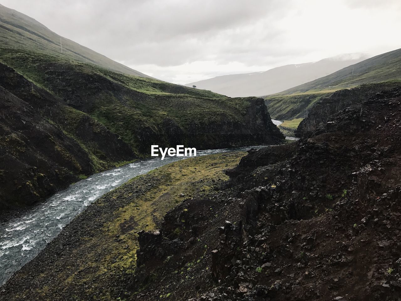 Scenic view of waterfall against sky
