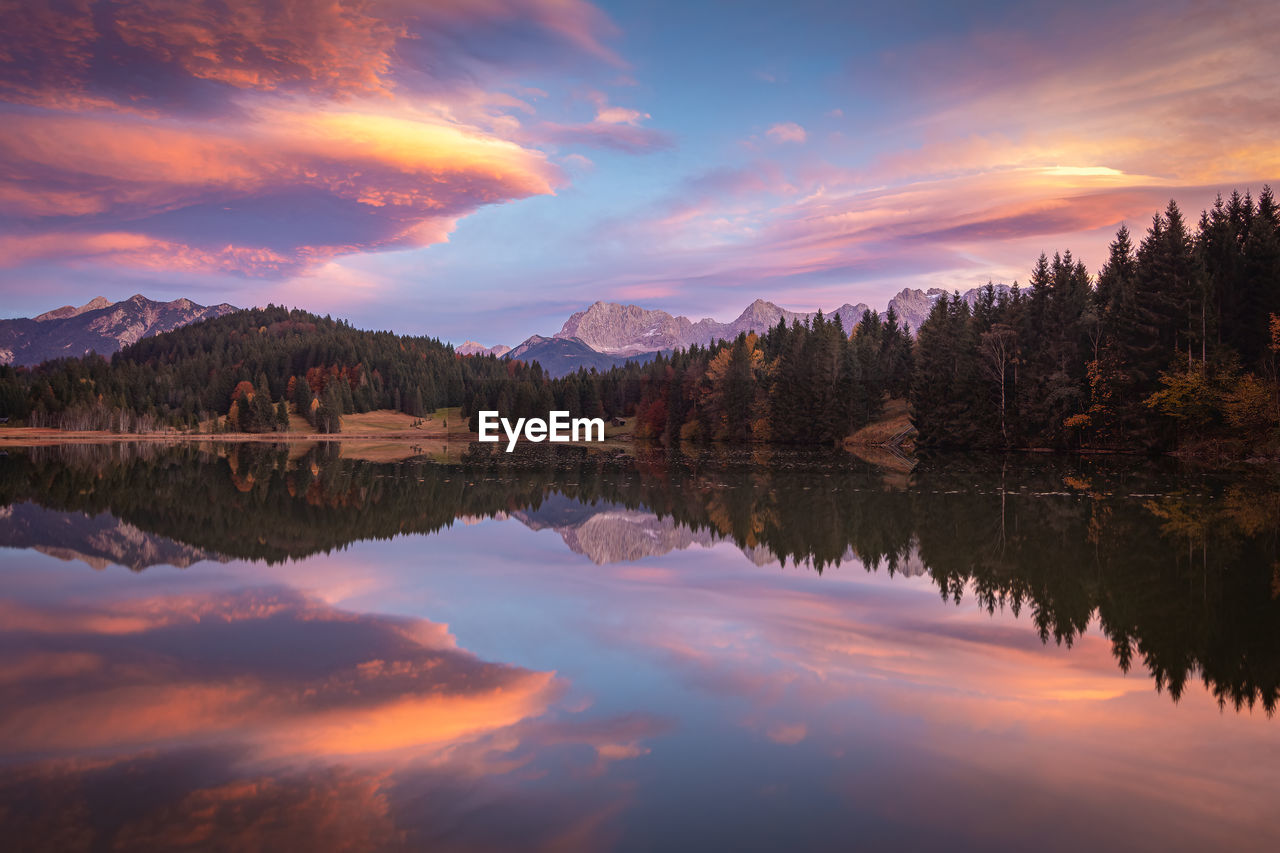 Scenic view of mountain lake against sky during sunset