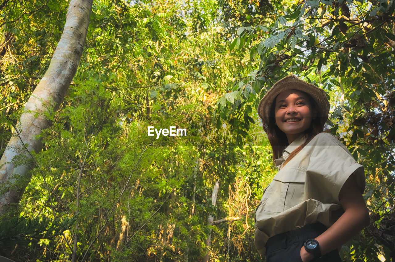 Happy young women surrounded by rainforest  ,  inspiration , freedom and recreation concept