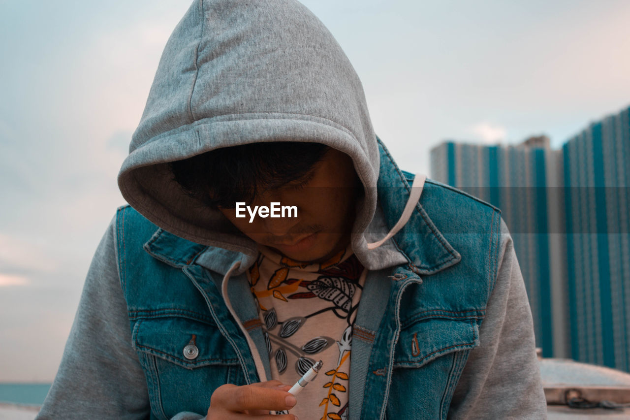 Close-up of young man smoking cigarette