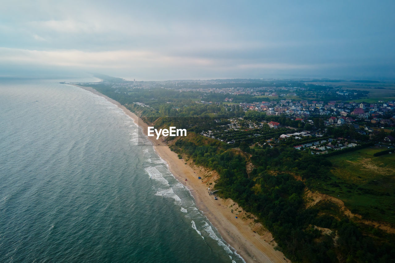 Aerial view of baltic sea beach with swimming people in wladyslawowo, poland