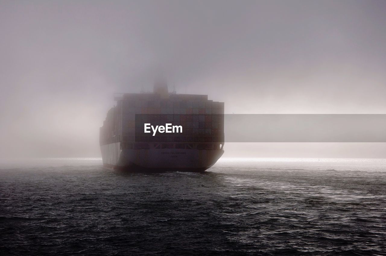 Cargo ship on sea during foggy weather