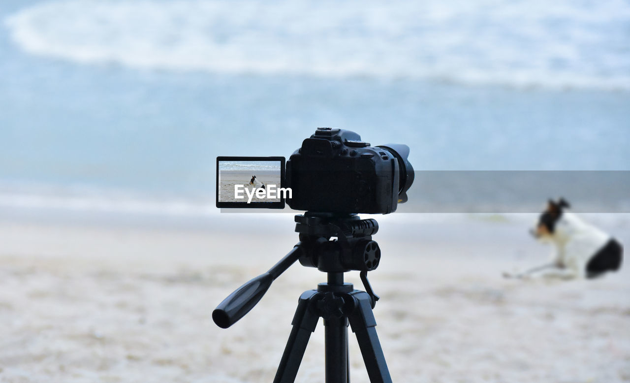 tripod, land, camera, beach, technology, sea, water, photographic equipment, focus on foreground, filming, nature, photographing, no people, day, activity, blue, film industry, scenics - nature, sky, outdoors, sand