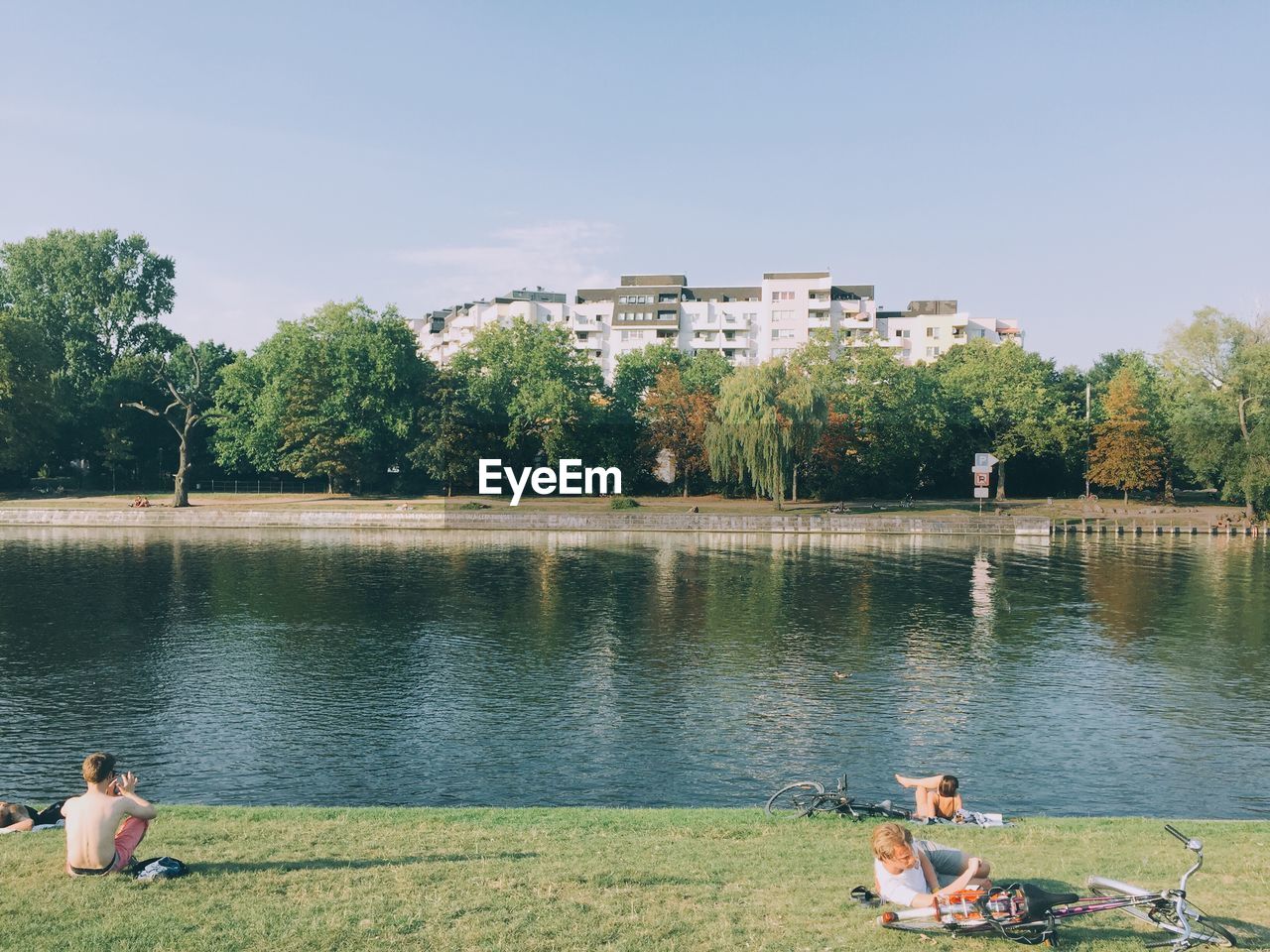 PEOPLE SITTING ON BENCH