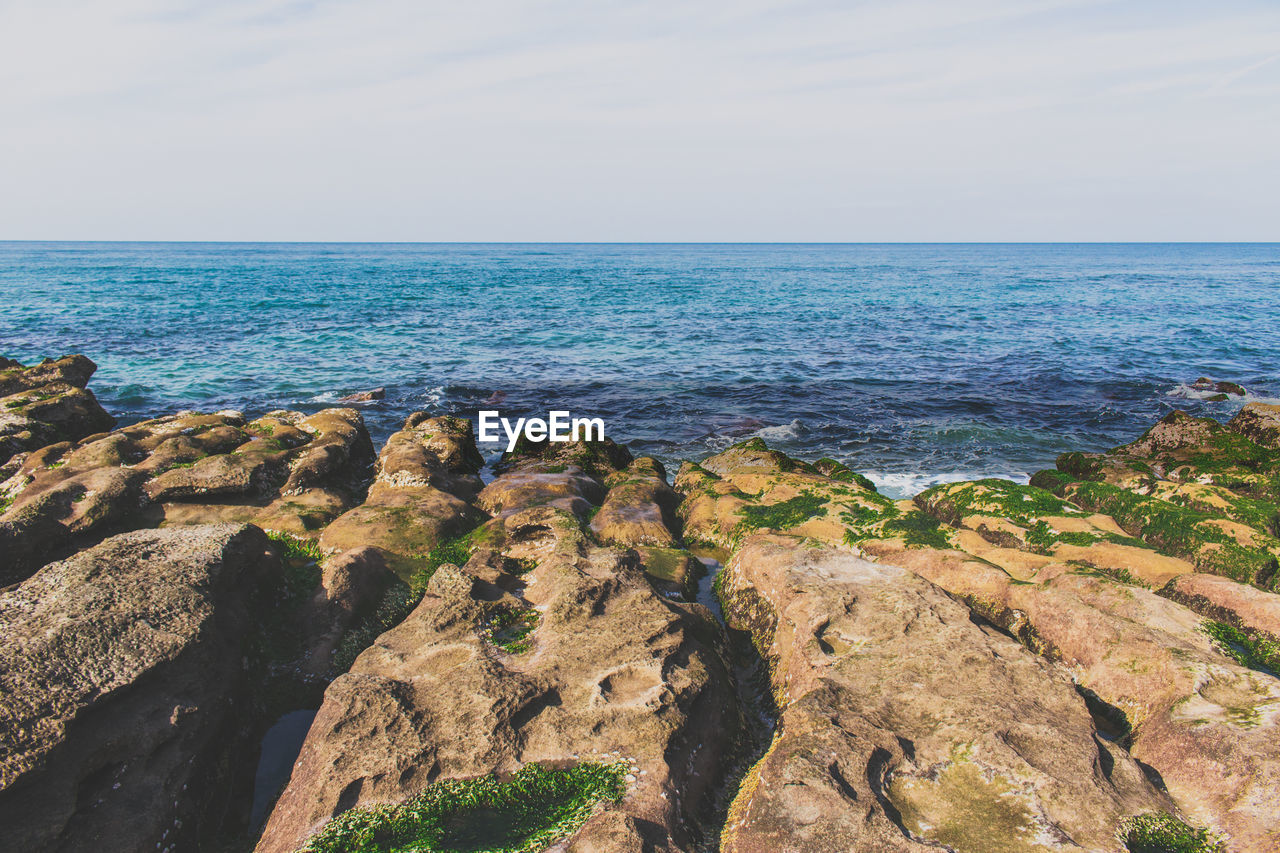 Scenic view of sea against cloudy sky