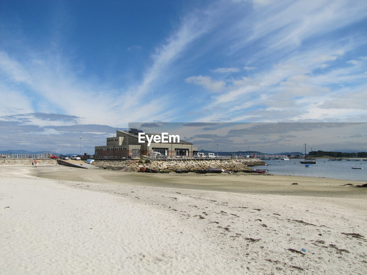 BUILDINGS ON BEACH AGAINST SKY