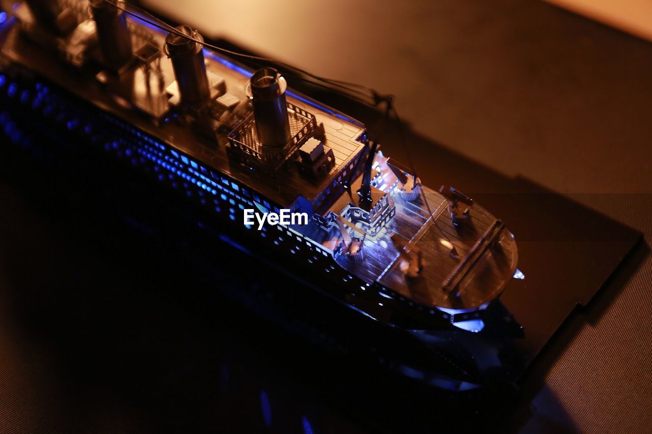 High angle view of illuminated model ship on table