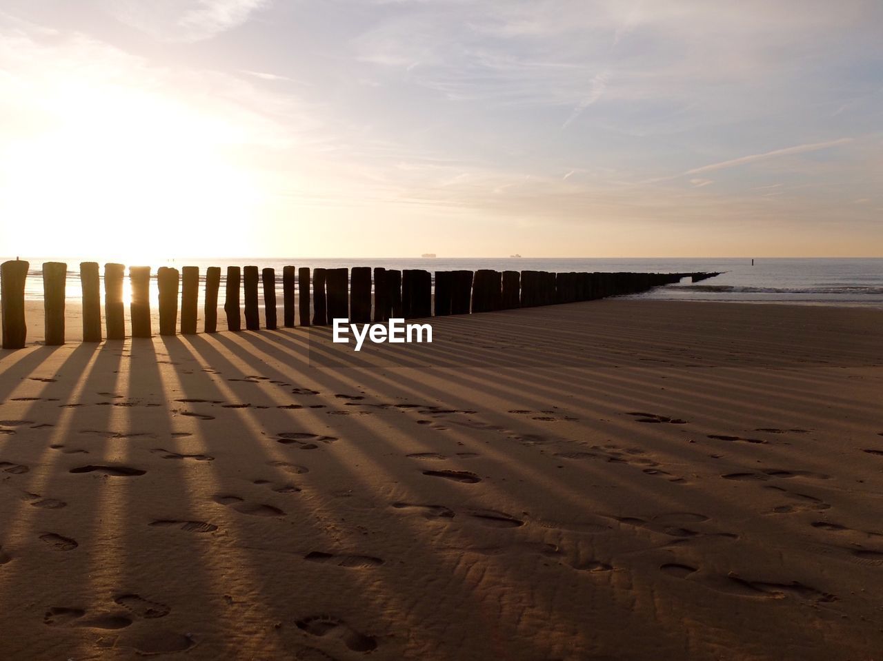 Scenic view of beach against sky during sunset