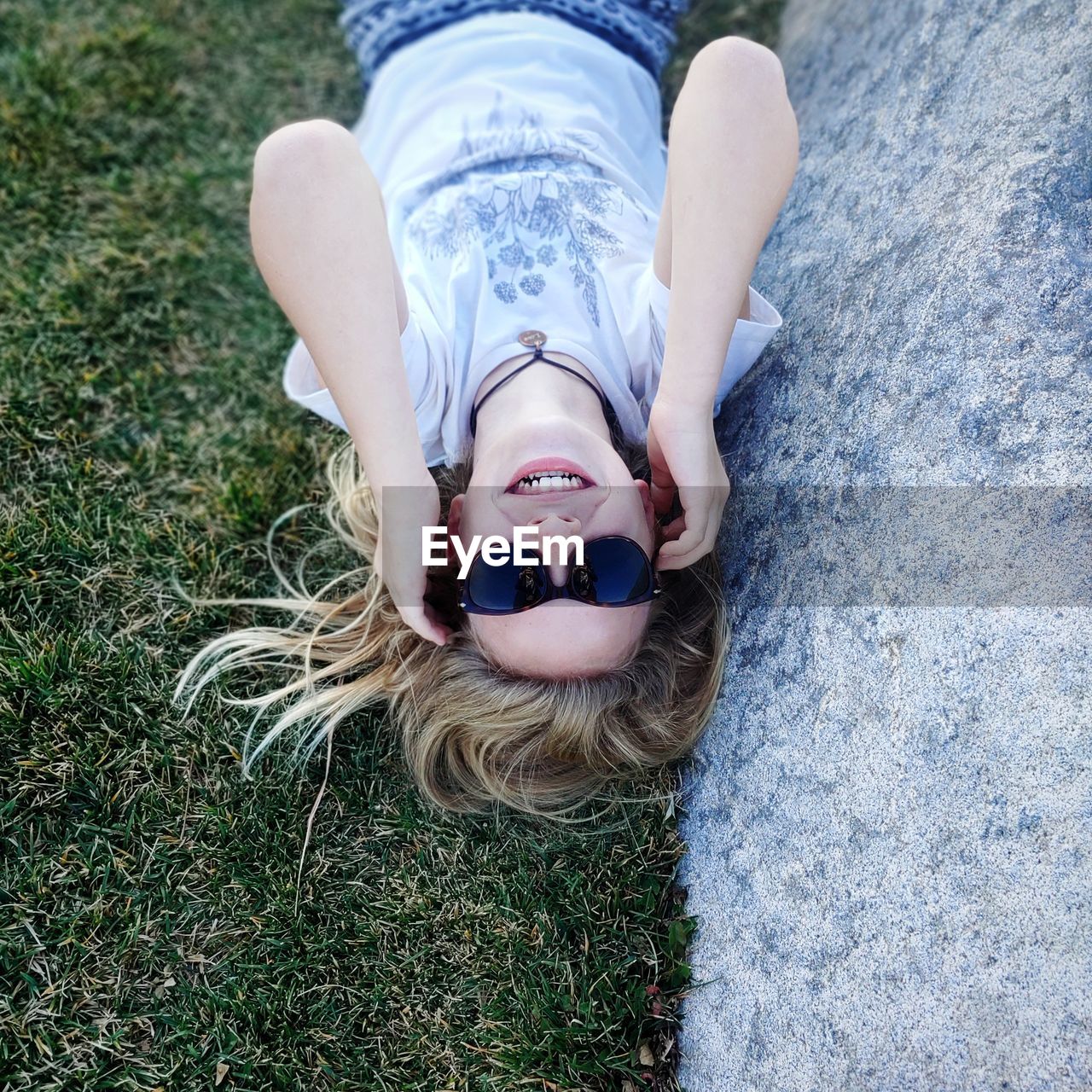 High angle view of woman lying on grass