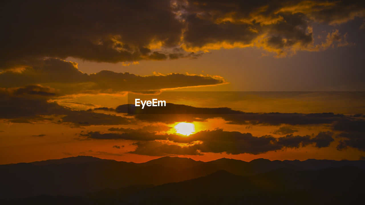 Scenic view of dramatic sky during sunset