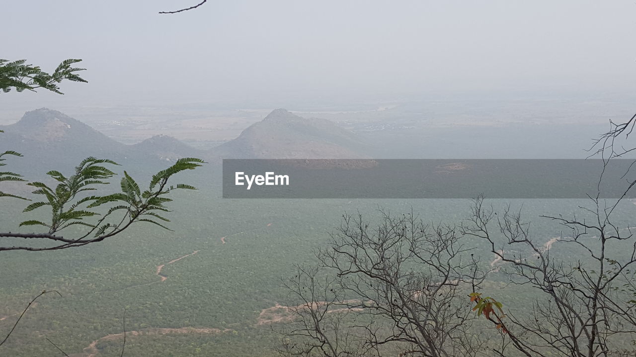 SCENIC VIEW OF MOUNTAINS AND SEA AGAINST CLEAR SKY