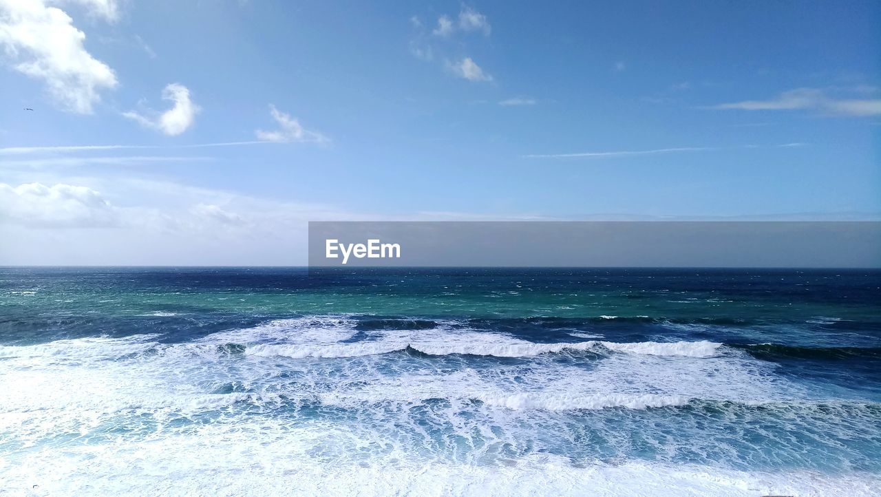 Scenic view of sea against blue sky