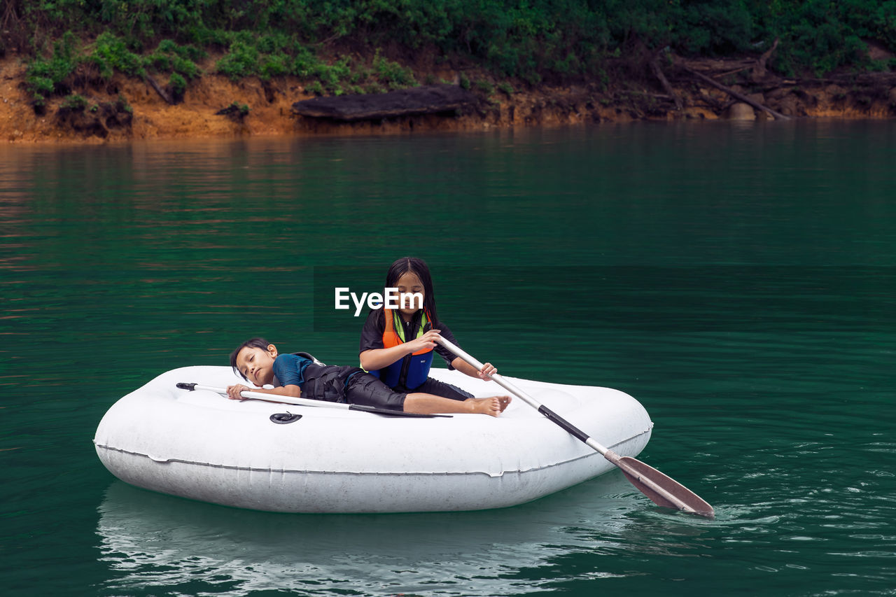 Woman sitting on boat in lake