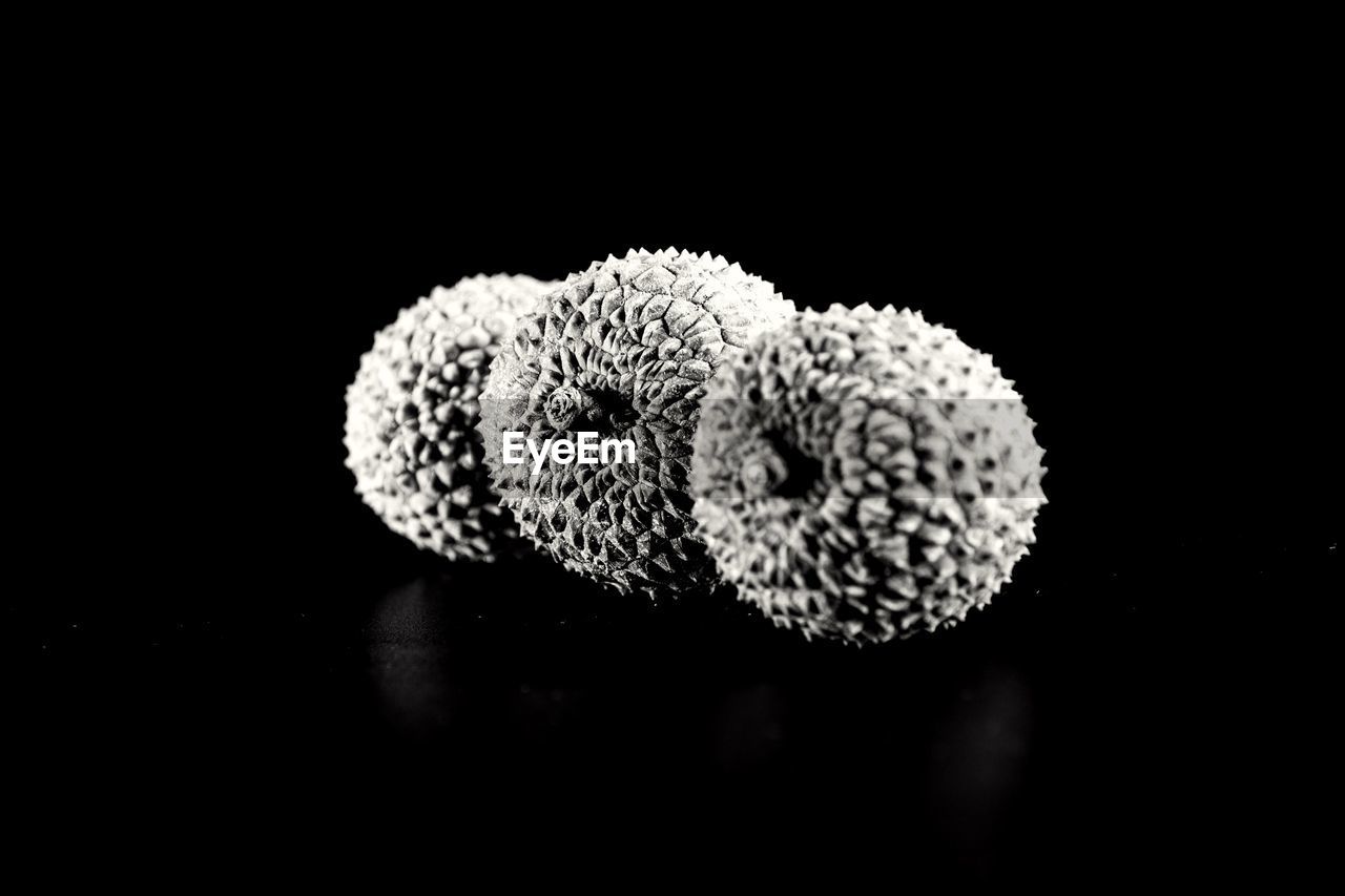 Close-up of lychees over black background