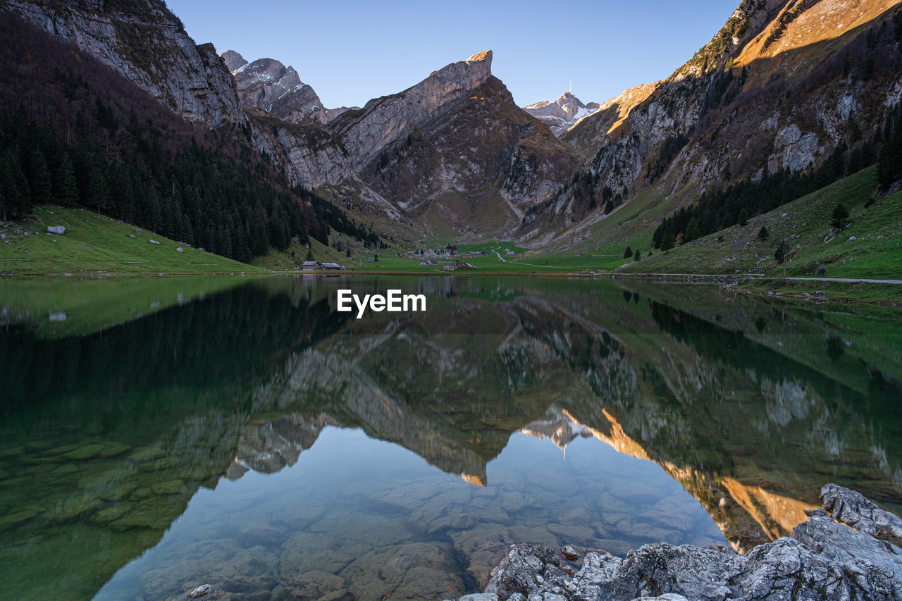 Scenic view of lake and mountains against sky