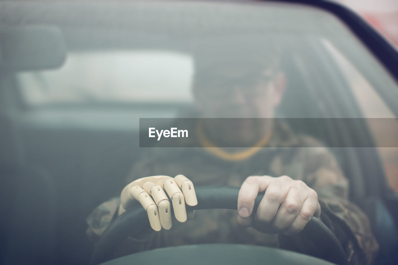 CLOSE-UP OF MAN HOLDING CAR