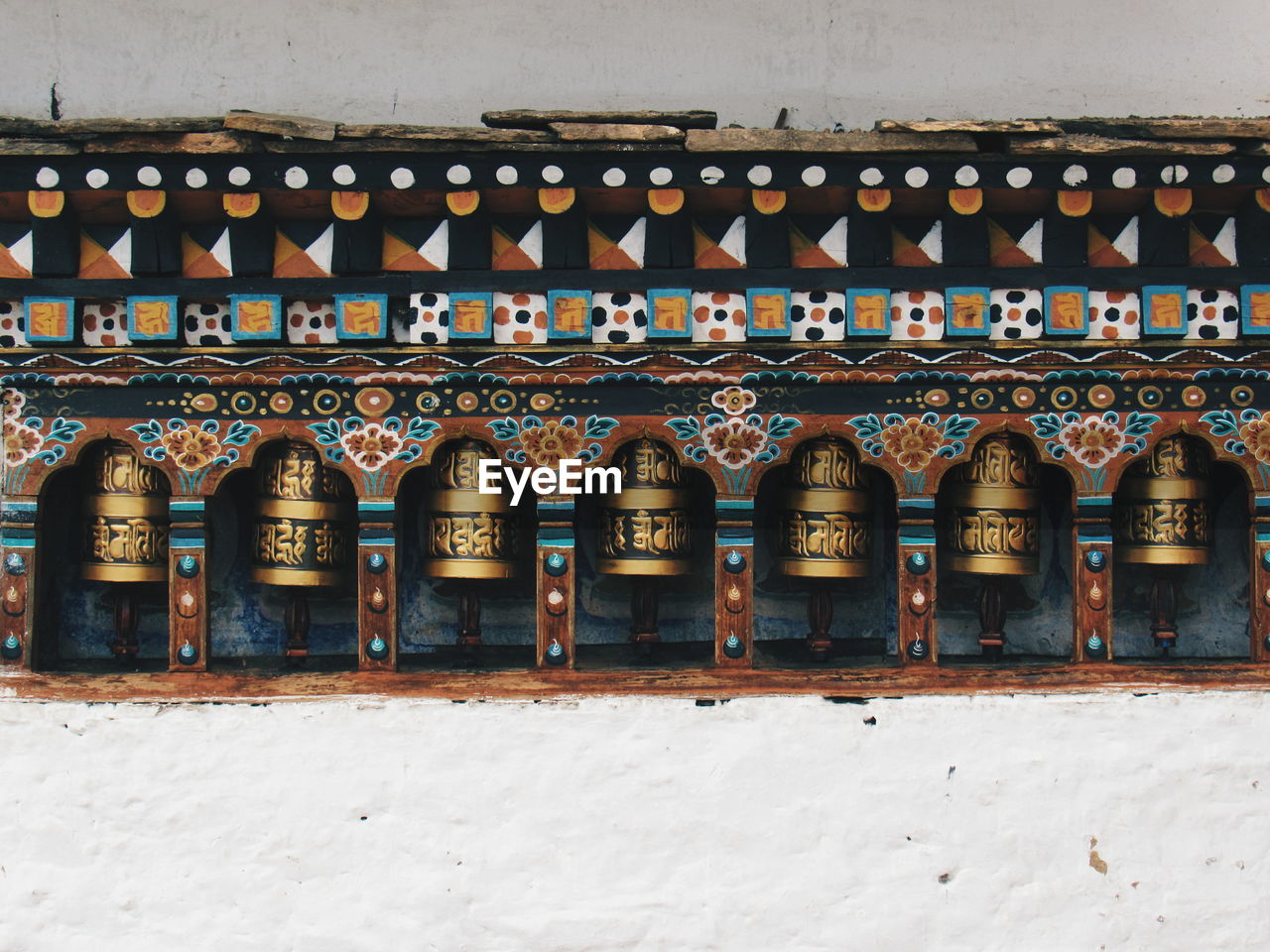 Prayer wheels on temple wall