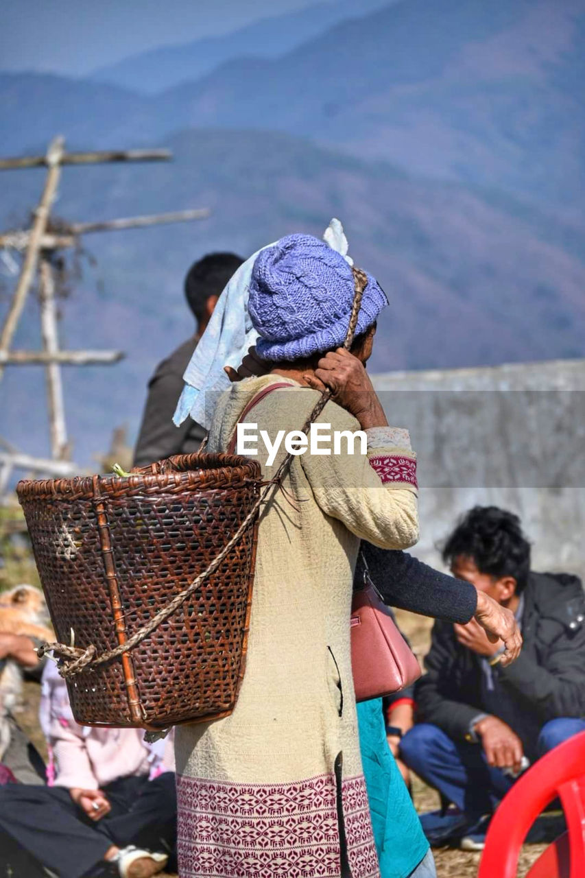 Woman with basket standing outdoors